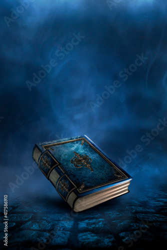 Fototapeta Magic vintage fantasy book on a dark background, landscape, smoke, fog, neon moonlight in the dark