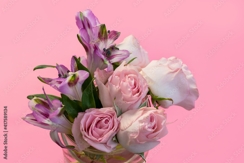 a bouquet of beautiful flowers on a pink background copy the space. the concept of spring, holiday and beauty