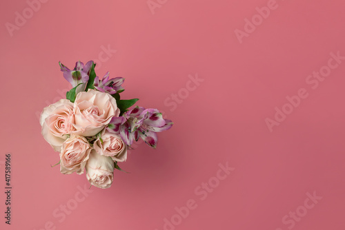 Fototapeta Naklejka Na Ścianę i Meble -  a bouquet of beautiful flowers on a pink background copy the space. the concept of spring, holiday and beauty