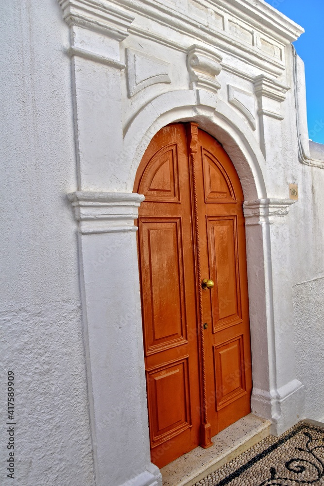 wooden door in the historic greek town of Lindos in Greece on a holiday day