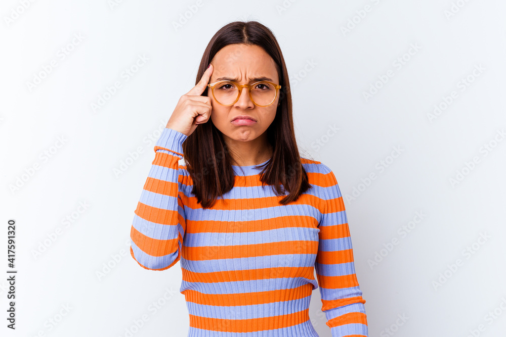 Young mixed race woman isolated pointing temple with finger, thinking, focused on a task. Young mixed race woman isolated pointing temple with finger, thinking, focused on a task.