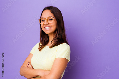 Young mixed race woman isolated who feels confident, crossing arms with determination.