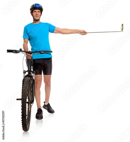 Full length portrait of man with bycicle taking photo on white background, bike blogger filming himself for YouTube channel