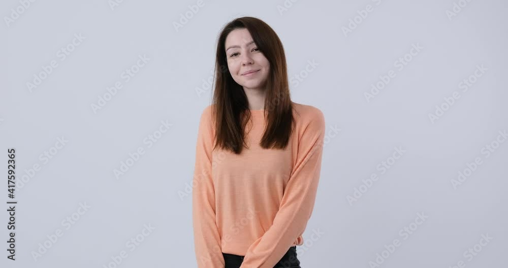 Beautiful caucasian woman with pretty face, gentle shy looking at camera