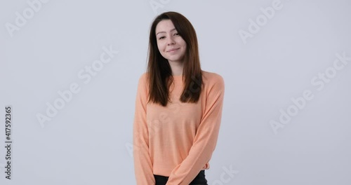 Beautiful caucasian woman with pretty face, gentle shy looking at camera
