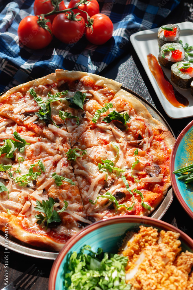 Yummy homemade pizza on a buffet table in a beautiful setting, sunny lighting Yummy homemade pizza on a buffet table in a beautiful setting, sunny lighting