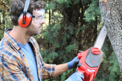 Candid of lumberjack holding a chainsaw
