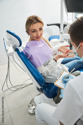 Dental specialist is listening to woman complaints