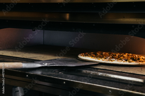 A pizza in a oven burning. Before baking. Cooking process