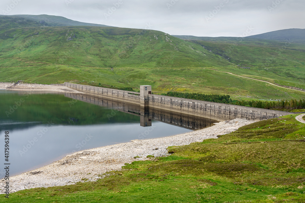 The dam wall of Loch Daimh reservoir water supply in the Scottish Highlands, UK landscapes.