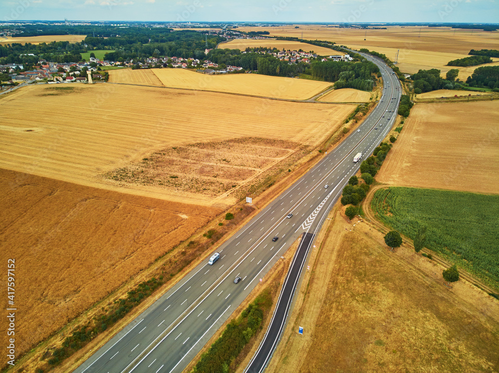 Aerial drone view of beautiful French countryside and six-lane motorway in France