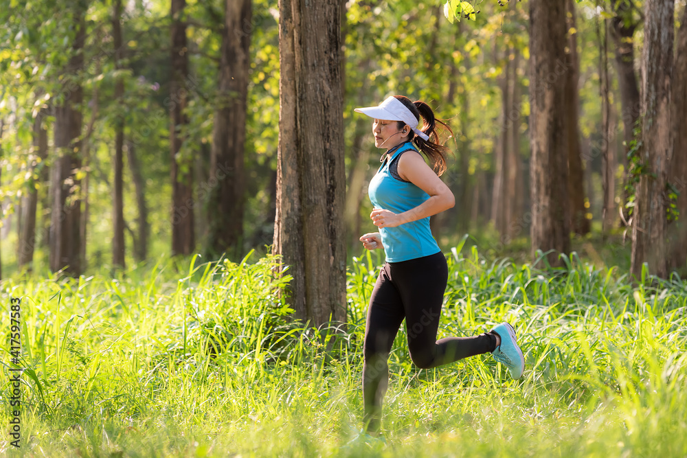 Healthy woman jogging run and workout in forest outdoor. Asian runner  people exercise gym with fitness session, nature park background. Stock  Photo | Adobe Stock