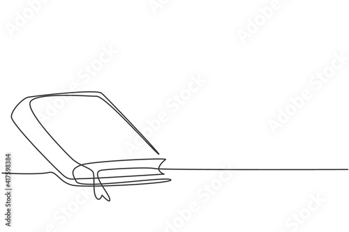 Single one line drawing of closed book on table at university library. Back to school minimalist, education concept. Continuous simple line draw style design graphic vector illustration