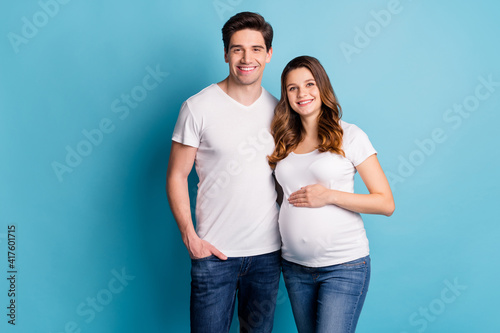 Photo of charming positive good mood cheerful family waiting baby hand arm tummy isolated blue color background