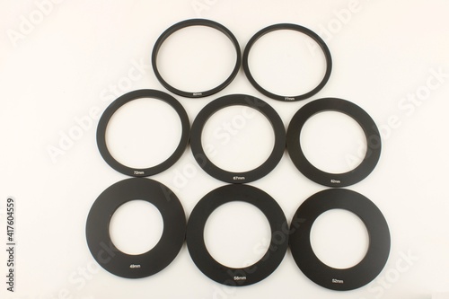 Selection of different size camera lens adaptor rings photo
