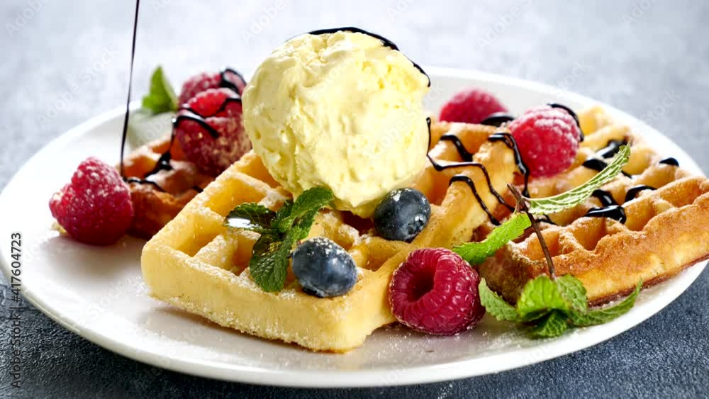 waffle with vanilla ice cream, berry fruit and chocolate