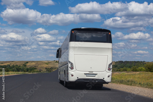 Tourist bus moves along a country road © Yuri Bizgaimer
