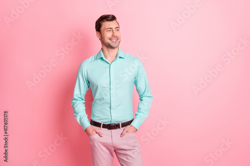 Photo portrait of young businessman looking empty space smiling confident isolated on pastel pink color background © deagreez