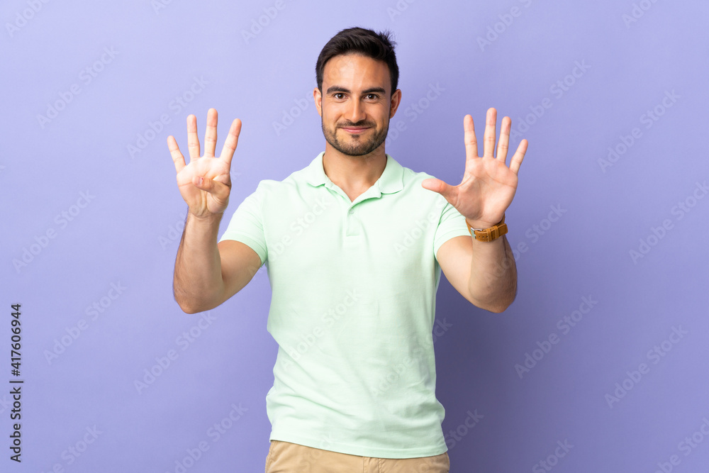 Young handsome man isolated on purple background counting nine with fingers