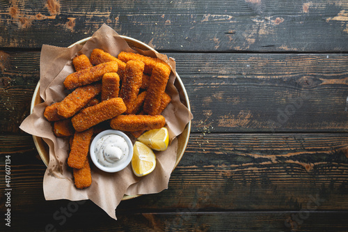 Canvas Print Fish sticks with sauce on the table
