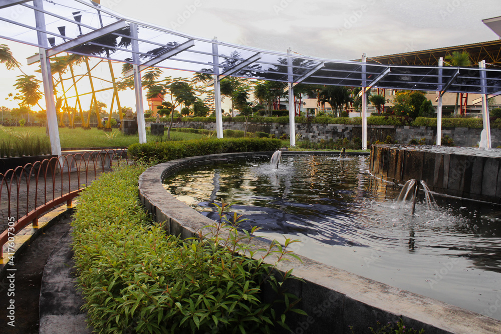 fountains and vegetation around it. Sunset background concept fountains and vegetation around it. Sunset background concept