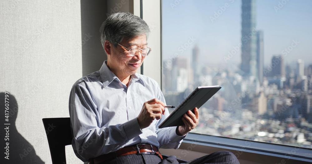 man use tablet near window man use tablet near window