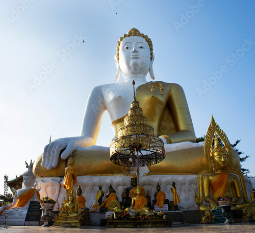 Big golden buddha image statue of Wat Phra That Doi Kham Temple for thai people and foreign travelers travel visit and respect praying at Mae Hia city on November 10, 2020 in Chiang Mai, Thailand © tuayai