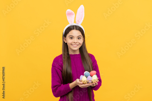 childhood happiness. child in rabbit costume hold painted eggs. time for egg hunt.