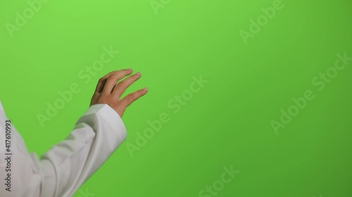Arab male hand touchscreen gestures on chroma key green screen background, like using a smart television, touch screen display, hologram