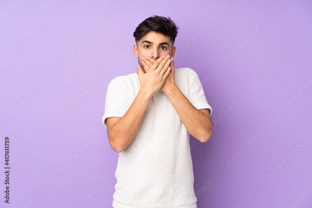 Arabian handsome man over isolated background covering mouth with hands Arabian handsome man over isolated background covering mouth with hands