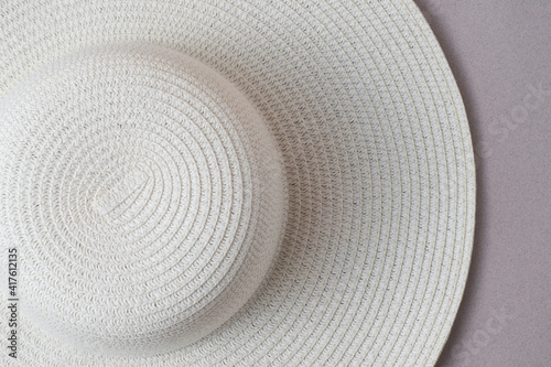 A large white beach lady's hat on a pastel beige background. The concept of vacation, vacation, travel, sales, black Friday.
