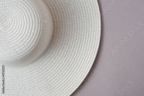 A large white beach lady's hat on a pastel beige background. The concept of vacation, vacation, travel, sales, black Friday.