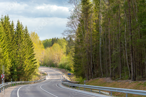Winding road down the hill in spring. © Ieva