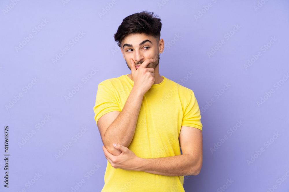 Arabian handsome man over isolated background having doubts and with confuse face expression Arabian handsome man over isolated background having doubts and with confuse face expression