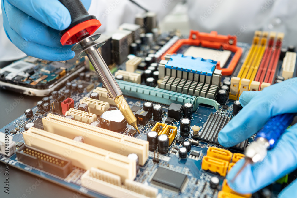 technician repairing inside of hard disk by soldering iron. Integrated Circuit. the concept of data, hardware, technician and technology. technician repairing inside of hard disk by soldering iron. Integrated Circuit. the concept of data, hardware, technician and technology.
