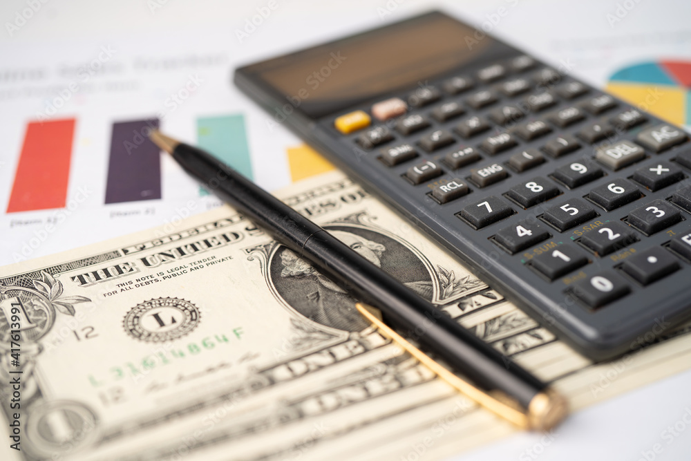 Pen and calculator on chart or graph paper. Financial, account, statistics and business data concept. Pen and calculator on chart or graph paper. Financial, account, statistics and business data concept.