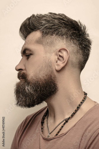 Close-up image of serious brutal bearded man on white background.