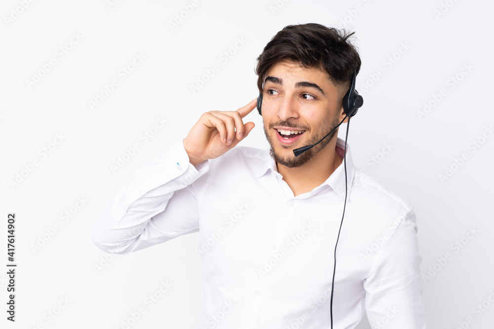 Telemarketer Arabian man working with a headset isolated on white background Telemarketer Arabian man working with a headset isolated on white background