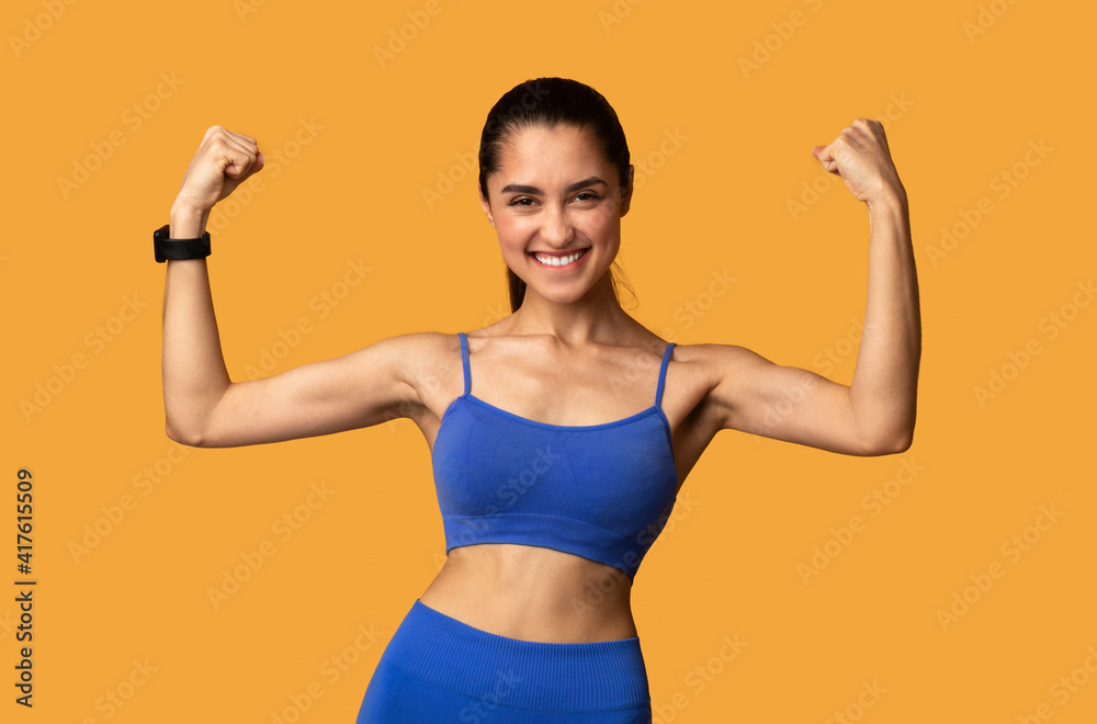 Happy sporty woman celebrating success gesturing at studio Happy sporty woman celebrating success gesturing at studio