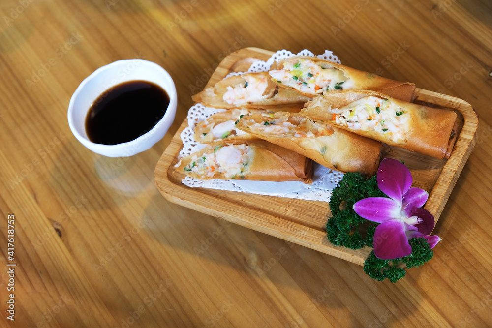 spring roll, traditional Chinese snack. A thin sheet of dough, rolled, stuffed and fried spring roll, traditional Chinese snack. A thin sheet of dough, rolled, stuffed and fried