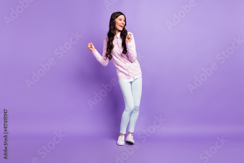 Full length body size view of attractive cheerful wavy-haired girl dancing having fun isolated on violet color background