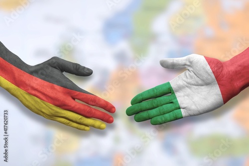 Italy and Germany - Italian and German - Flag handshake symbolizing partnership and cooperation
