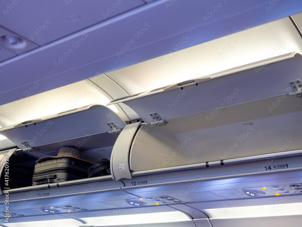 Opened locker in cabin with luggage. Opened locker in cabin with luggage.