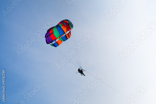 Parasailing in blue sky. Sports, active leisure, travel, vacation concept