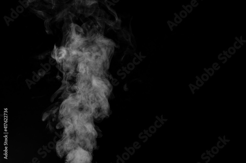 Figured smoke on a dark background. Abstract background, design element, for overlay on pictures.