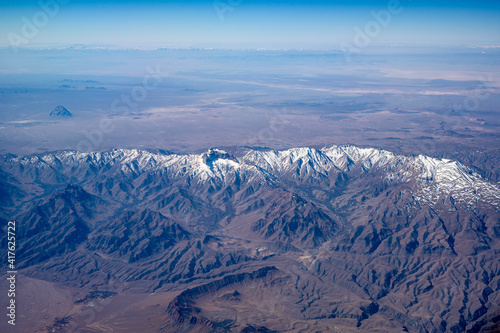 Flight on airplane over mountains