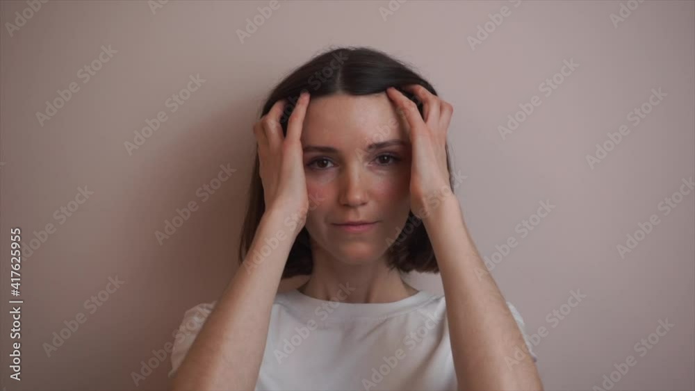 A beautiful European girl with dark hair straightens her hair. Slow motion. A beautiful European girl with dark hair straightens her hair. Slow motion.