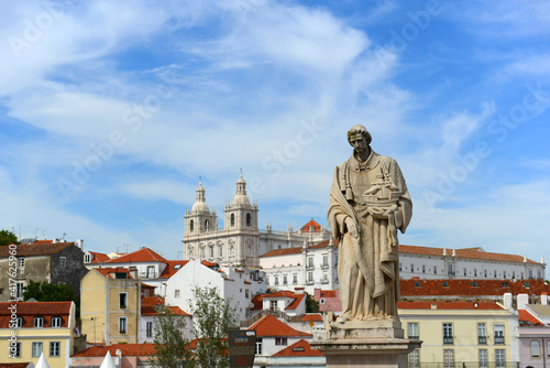 Statue of Santa Luzia (Saint Lucia) at Miradouro de Santa Luzia, with Monastery of Sao Vicente de Fora at the background in Lisbon, Portugal.