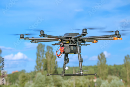 Big black homemade eight motor hexacopter on sky background.