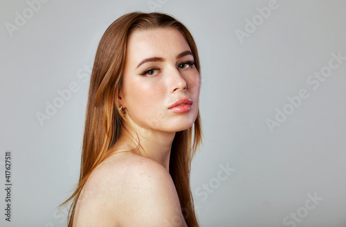Closeup portrait of a face of the young pretty woman with a healthy skin. Beautiful face of young white woman with a clean skin. Skin care concept.